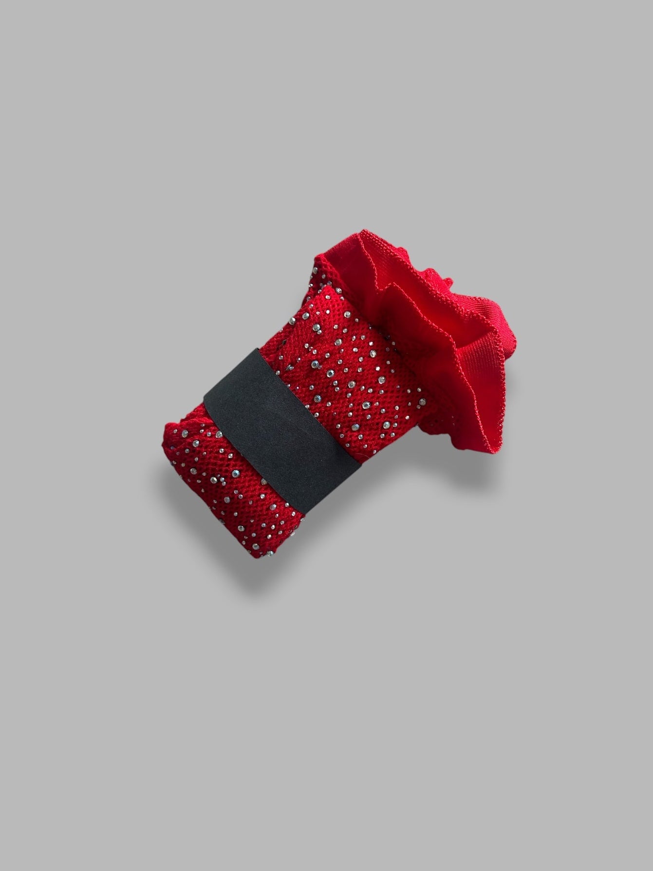 Red fishnet tights with rhinestones on a grey background